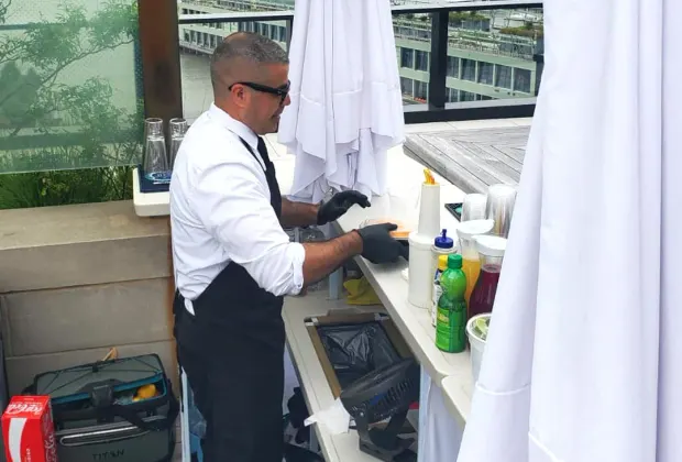 Professional event mixologist preparing a signature cocktail