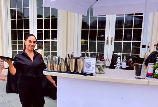 Professional event server assisting guests at a private celebration