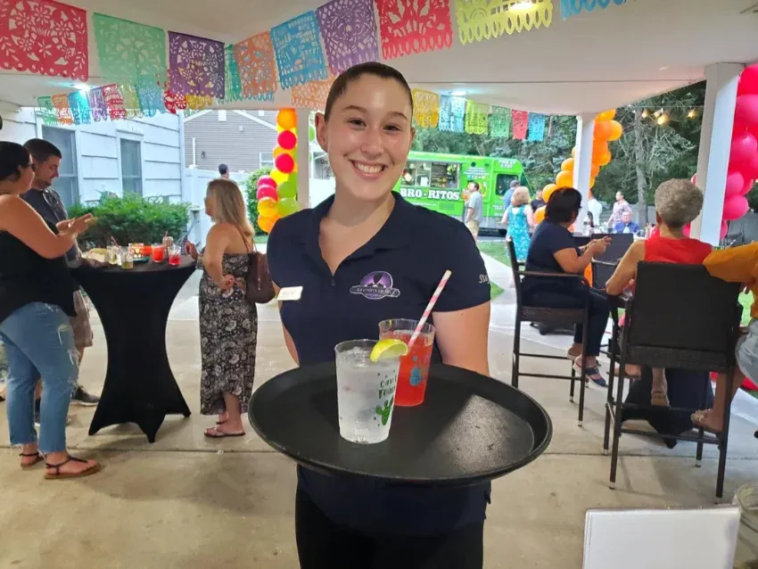 server carrying a tray with cocktails in a private party in NJ hire Event Staff Servers